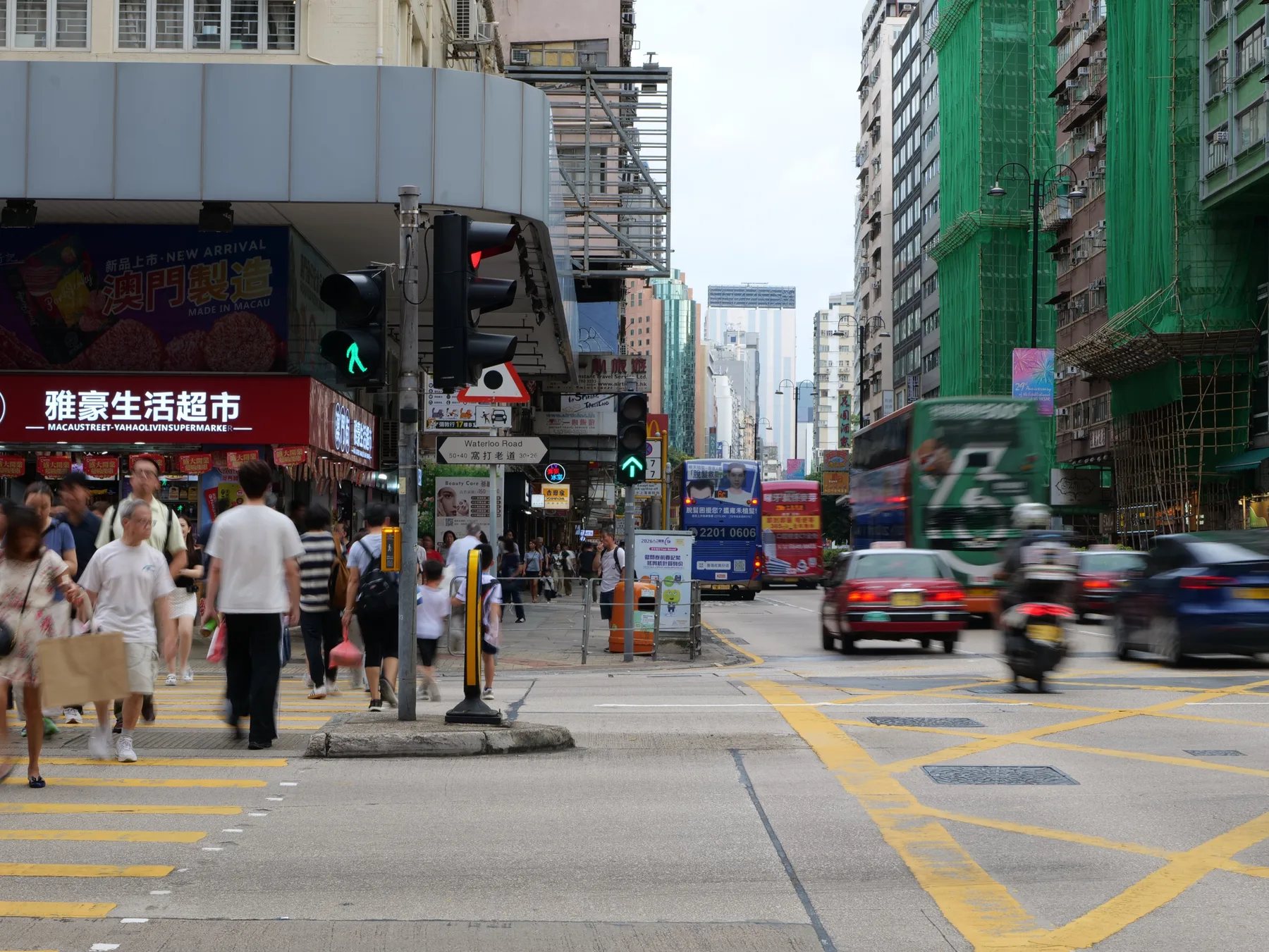 Pedestrians and traffic moving through a crowded intersection on Waterloo Road